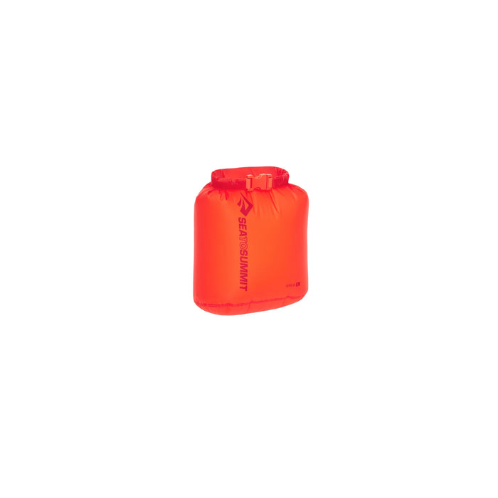 The Sea to Summit Ultra-Sil Dry Bag is a bright orange, rectangular nylon bag with a roll-top closure and buckle. The Sea to Summit logo and name appear vertically on its side. It’s shown against a plain white background.